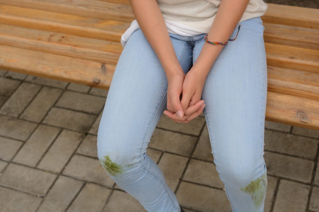 Girl Sitting In Dirty Jeans
